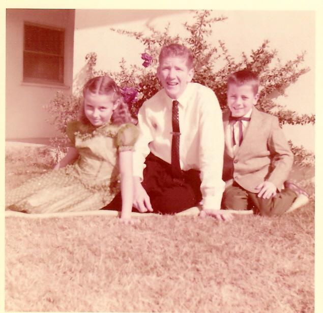 Sue Ken & Les Tiffany in front of rose bush Seven Sisters about 1955